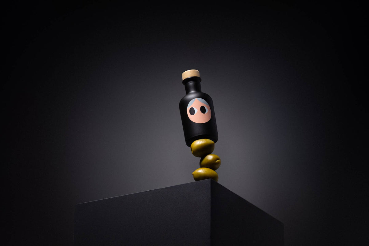 A single yiayia and friends bottle balanced on olives