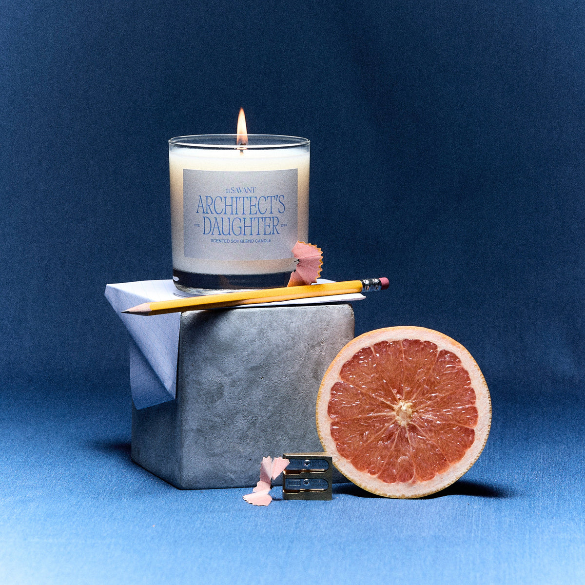 The New Savant Architect's Daughter Candle with grapefruit, a pencil and graph paper