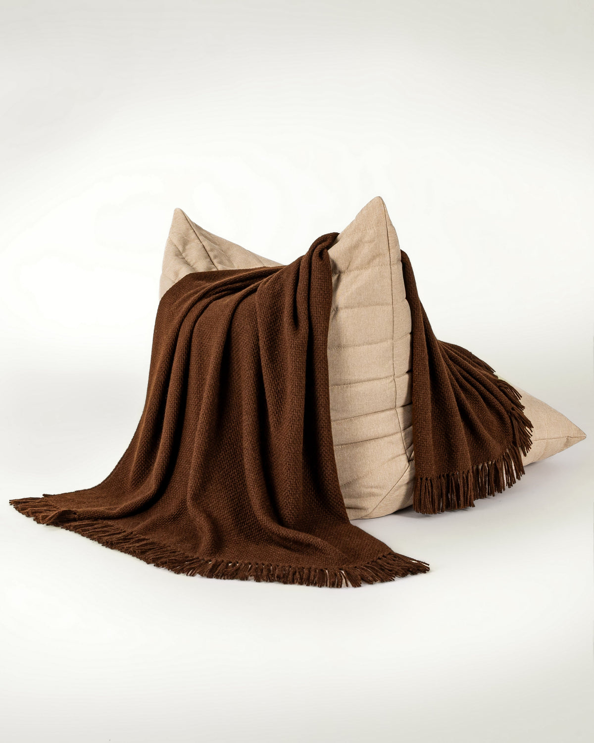Normy Alpaca Wool Blanket in Cocoa draped over a chair