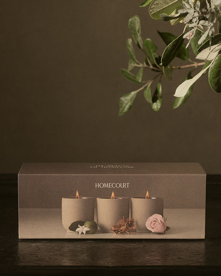 The three votives lit, in their clay vessels