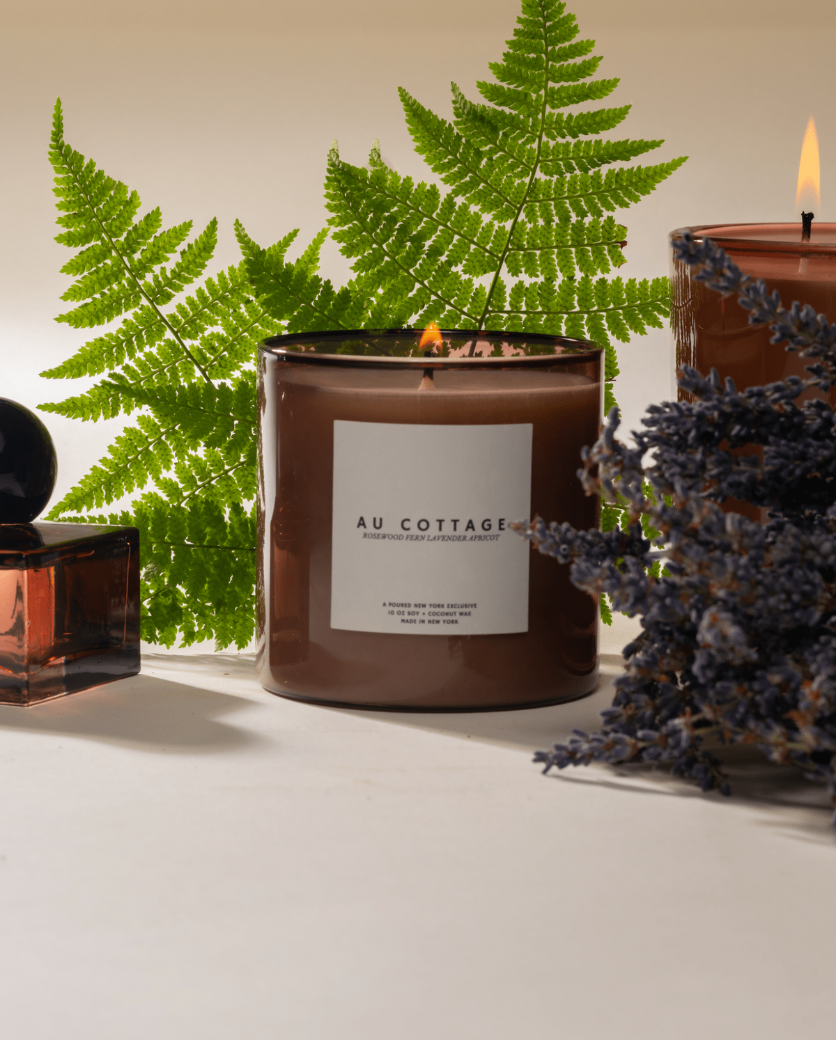 Poured New York Au Cottage candles lit, with lavender and fern