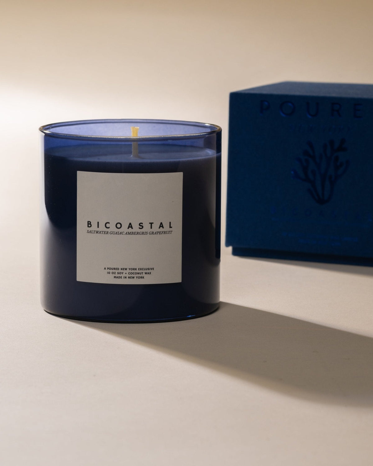 Bicoastal candle in blue glass with its printed box