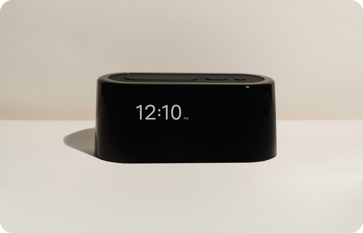 The nightlight, warm and low, on a nightstand