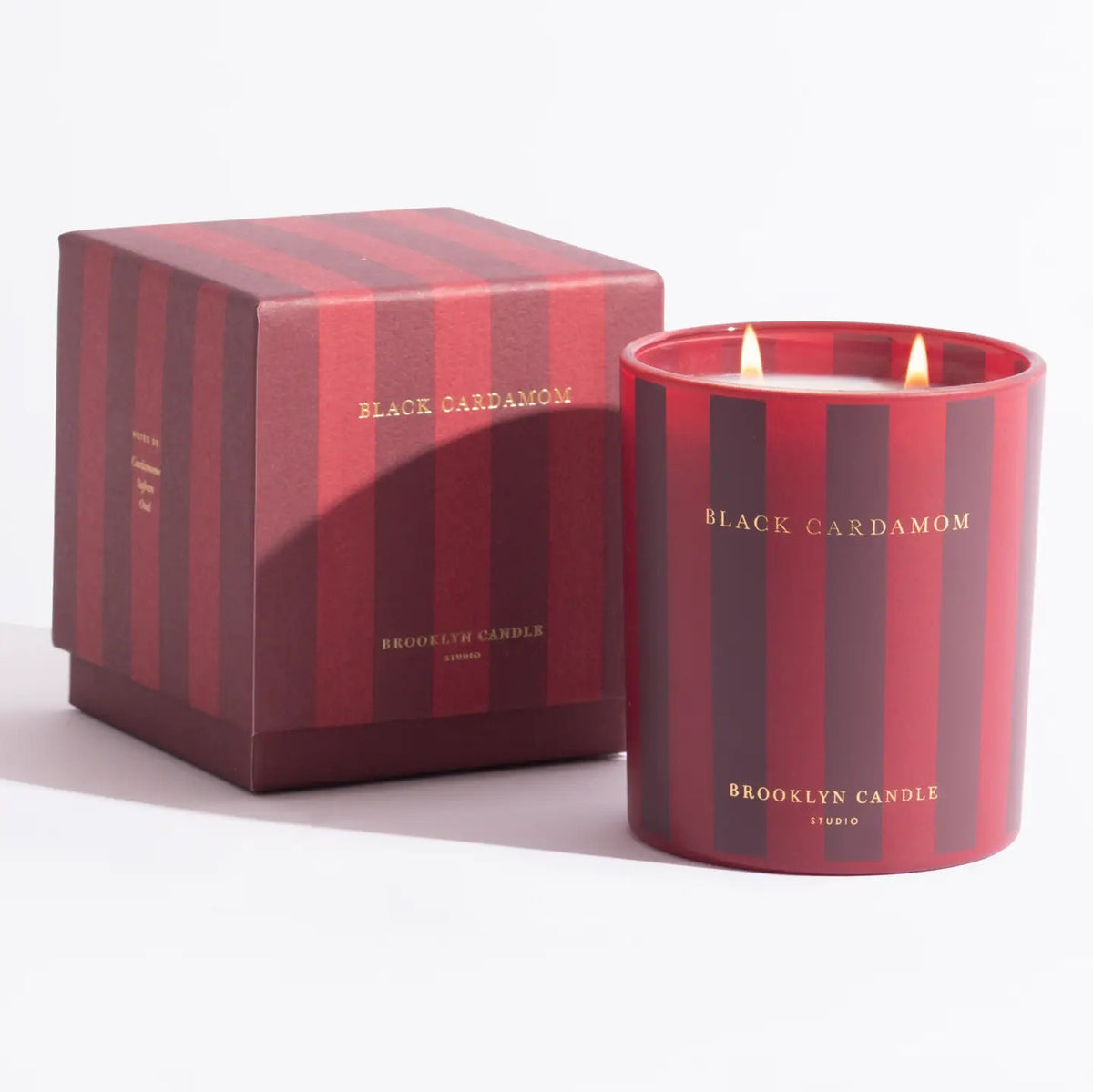 Brooklyn Candle Studio Black Cardamom candle with its striped gift box