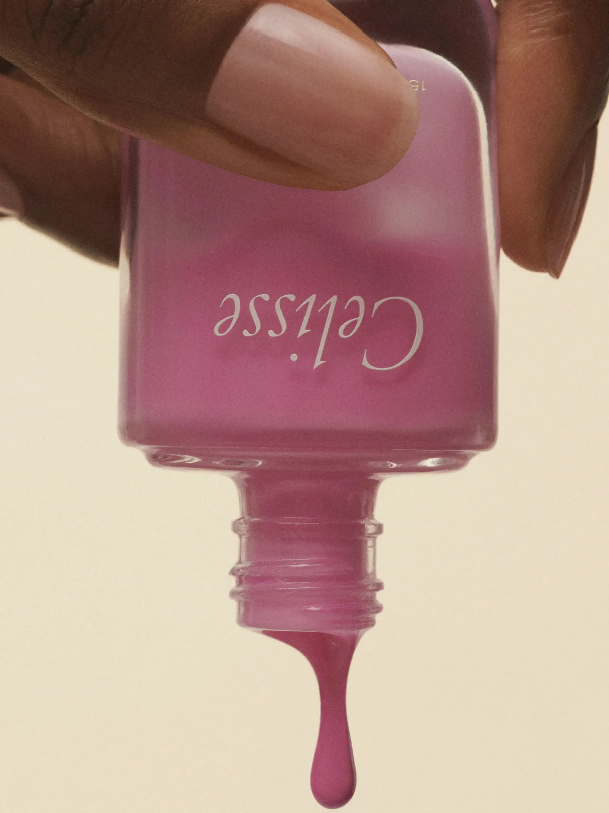 Celisse QuickCoat bottle held in one hand