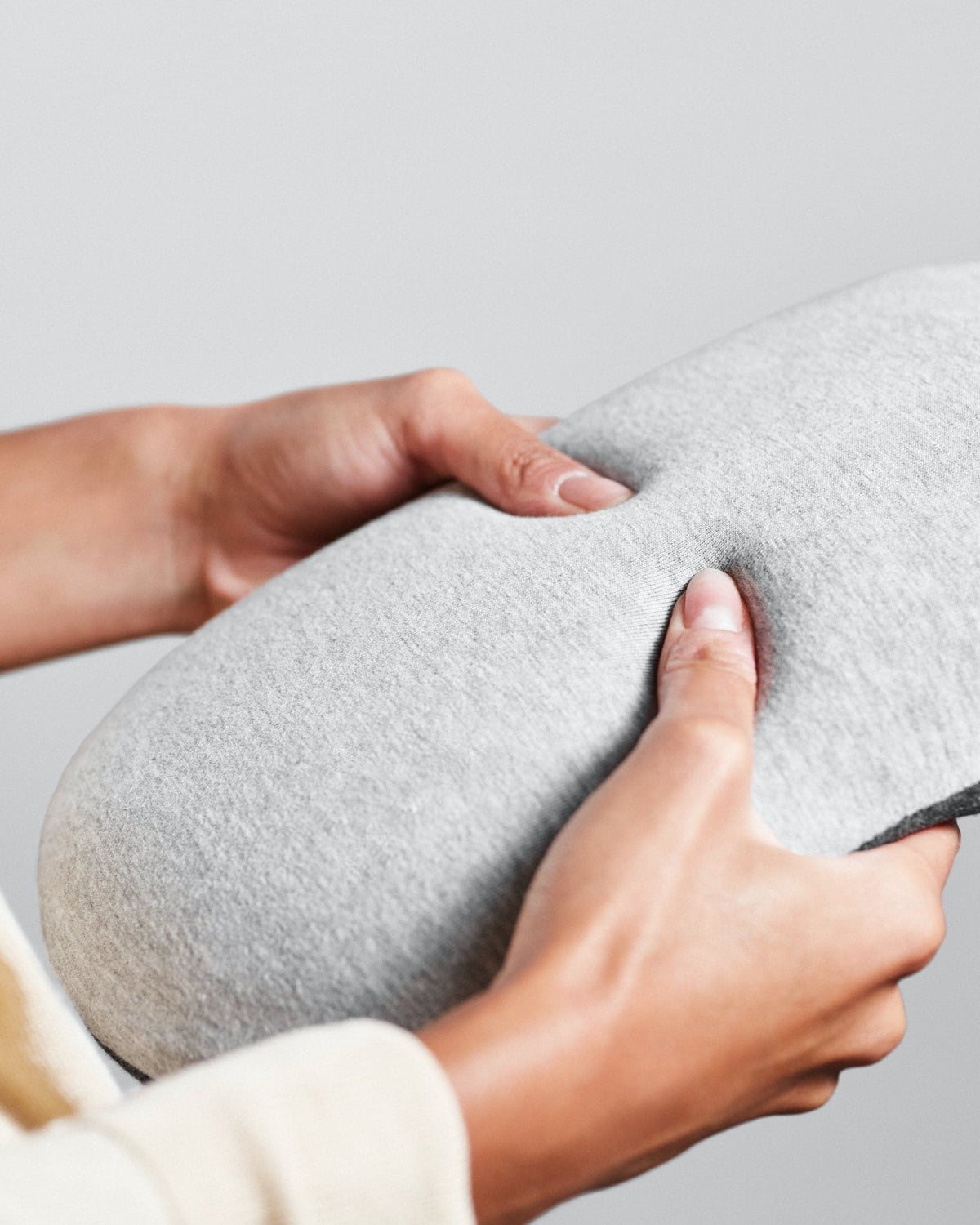 Hands pressing into the Ostrichpillow Heatbag cover
