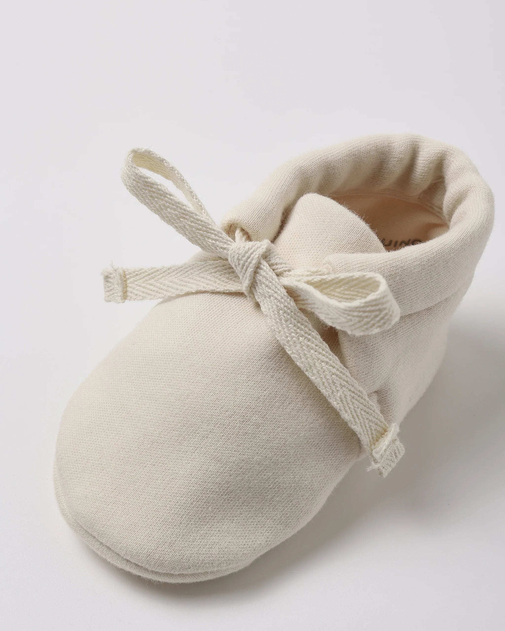 Quincy Mae baby booties in natural, detail of the ankle tie
