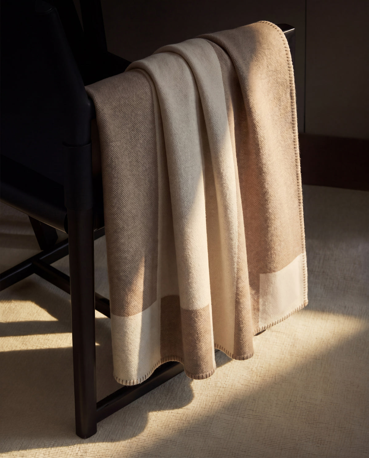 The throw over a chair, shown in a room